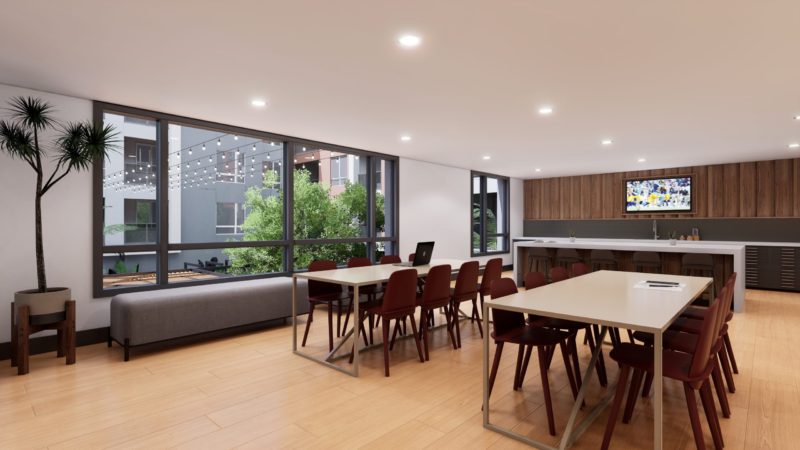 coworking tables and kitchen at broadstone archive apartments