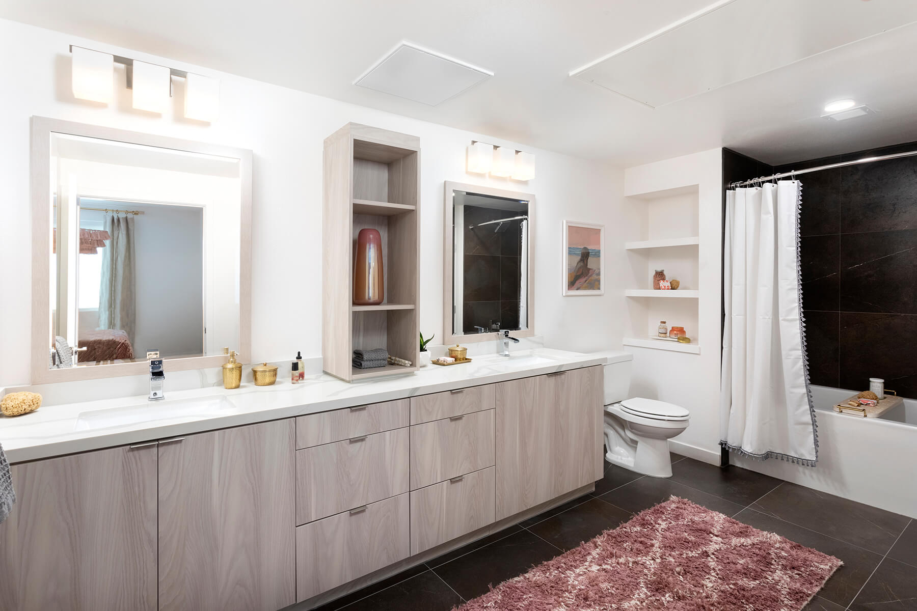 Spacious bathroom with double vanity and oversized bath tub. 